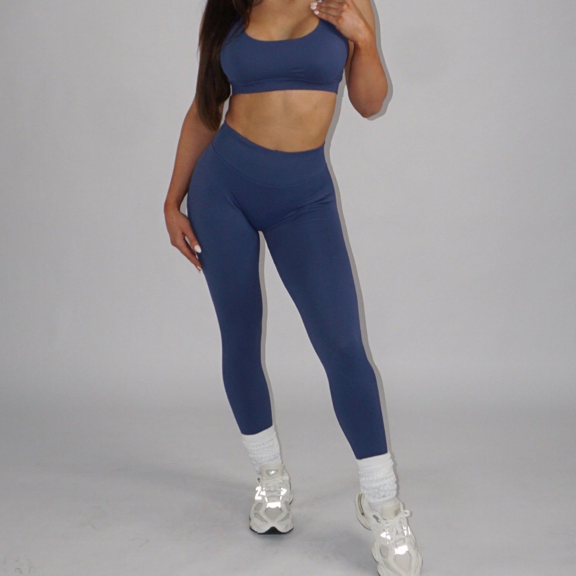 Sapphire blue full-length leggings with a low-rise elastic waistband, seamless design, and lightweight, breathable spandex-nylon fabric for comfort and style.